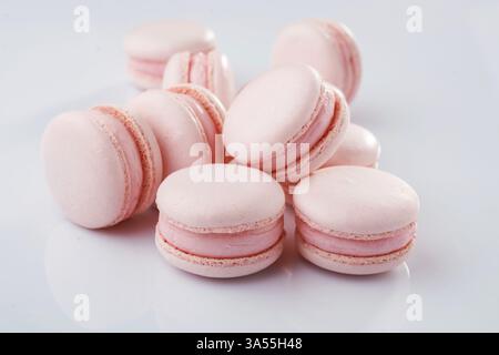 Pink colored. Bunch of macarons on the white surface. Stock Photo