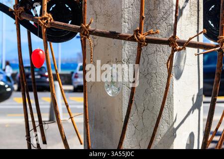 Colorful painted decorative Easter eggs hanging by an iron frame outside Stock Photo
