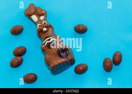 Easter chocolate bunny and chocolate eggs on blue background Stock Photo