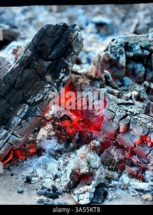 A close up of burning embers and ashes in the fire. Stock Photo