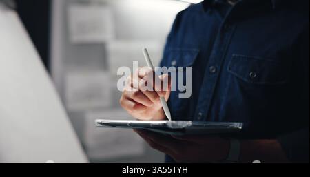 Tablet, stylus and hand of man in studio for animation development with creative project. Digital technology, sketching and male concept artist Stock Photo