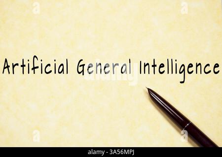 Handwritten Artificial General Intelligence text on vintage parchment with pen Stock Photo