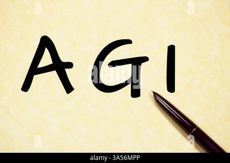 Handwritten AGI text with fountain pen on aged parchment paper Stock Photo