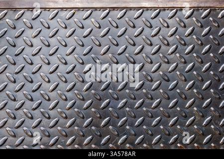 A view of the texture of a metal diamond plate, as a background. Stock Photo