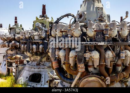 A view of several jet engines and parts at an aircraft graveyard. Stock Photo
