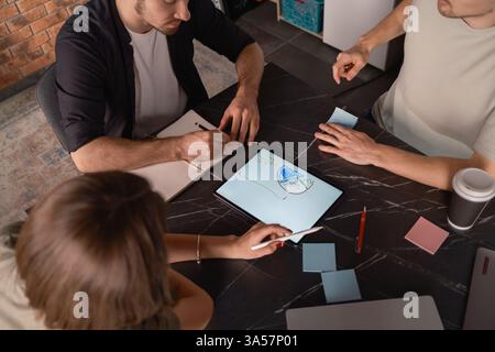 Team collaboration using a tablet in a modern workspace setting. Stock Photo