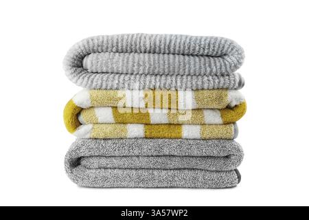 Soft fluffy striped grey and yellow bath towels folded in stack isolated on white background. Terry cloth, striped pattern towel texture, cotton bath Stock Photo