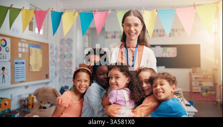 Happy, portrait and kids hugging teacher in classroom for bonding, learning and thank you. Love, children or students embracing woman educator for Stock Photo