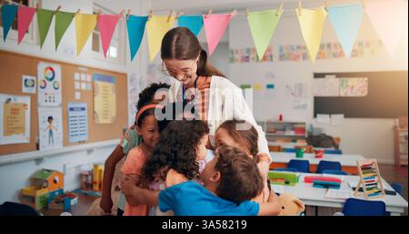 Happy, care and children hugging teacher in classroom for bonding, learning and thank you. Love, kids or students embracing woman educator for Stock Photo