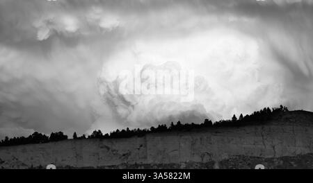Dramatic thunderstorm clouds or a supercell over Sacrifice Cliffs in black and white. Stock Photo