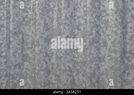 A grey metal surface with a pattern of small squares. The squares are of different sizes and are arranged in a random manner. Scene is somewhat chaoti Stock Photo