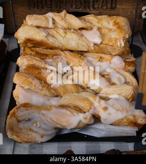 A stacked row of Cinnamon rolls on display in a market Stock Photo