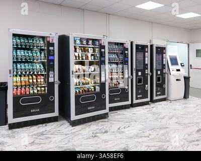Italy - March 20, 2025: Automatic dispensers of soft drinks, water and snacks and coffee in break coffee area Stock Photo