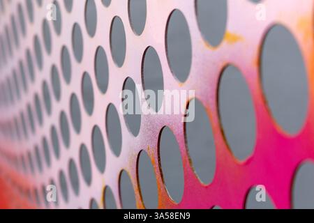 A closeup view of color blend schemes on a wall with a hole pattern. Stock Photo