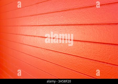 A view of an orange painted concrete wall, as a background. Stock Photo