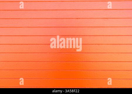 A view of an orange painted concrete wall, as a background. Stock Photo