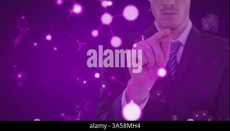 Interacting with virtual molecular structure, businessman in suit focusing on innovation Stock Photo