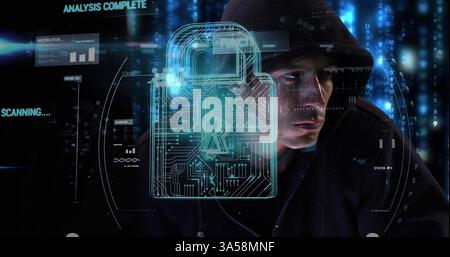 Hacker in hoodie surrounded by digital lock interface, focused on computer screen Stock Photo