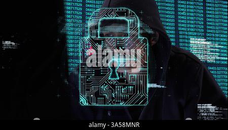 Hacker in hoodie surrounded by digital lock and binary code, focused on screen Stock Photo
