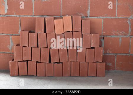 A stack of red concrete bricks or blocks at a construction site in Bejucal, Trinidad and Tobago. Stock Photo
