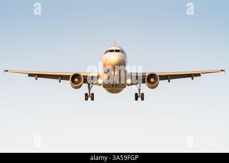 A passenger aircraft is ready to land at a commercial airport. Stock Photo