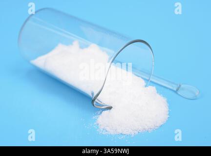 Thiourea powder on blue background Stock Photo