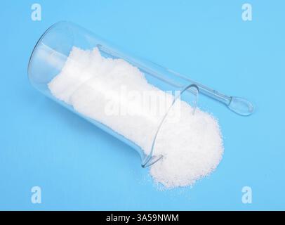 Thiourea powder on blue background Stock Photo