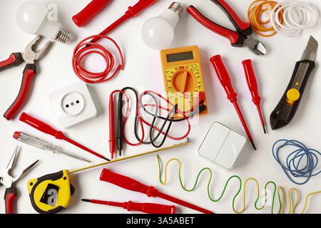 Different electrical tools on light background, flat lay Stock Photo