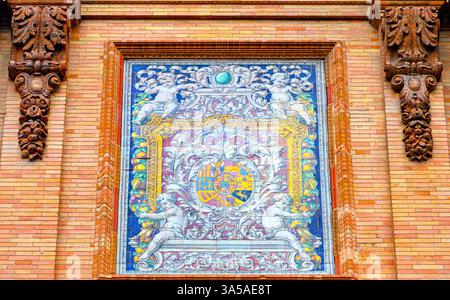 Ancient tile art decorating a brick wall on the exterior of a building. Stock Photo