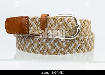 Fashionable Beige and Gray Woven Belt with Leather End and Silver Buckle. Stock Photo