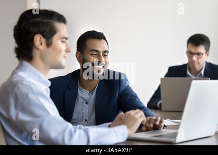 Two colleagues collaborating, reviewing new business platform on laptop Stock Photo
