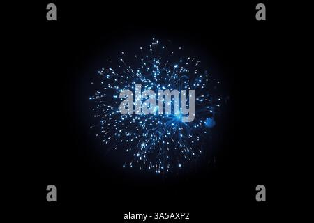 Single Blue Firework Burst Against Night Sky Stock Photo