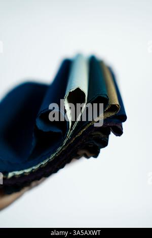 A collection of cotton fabric samples, showcasing colors and patterns on a white background. Great for casual fashion and textile design. Stock Photo
