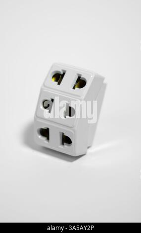 Universal Travel Adapter Electrical three Plug Converter Power Socket On White Background Stock Photo