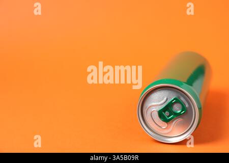 One tin can on orange background, closeup. Space for text Stock Photo