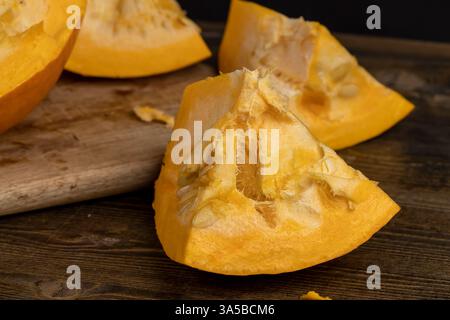 pumpkin with seeds cut into pieces, details of the pumpkin part with soft sweet flesh and large seeds Stock Photo