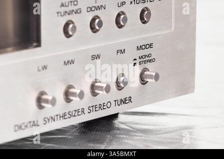 A close-up of a retro digital radio tuner, showcasing its signal strength meter, metal knobs, and a sleek metallic design. Ideal for concepts of techn Stock Photo