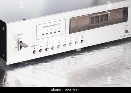 A close-up of a retro digital radio tuner, showcasing its signal strength meter, metal knobs, and a sleek metallic design. Ideal for concepts of techn Stock Photo