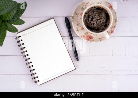 Top view of blank notepad and cup of coffee Stock Photo