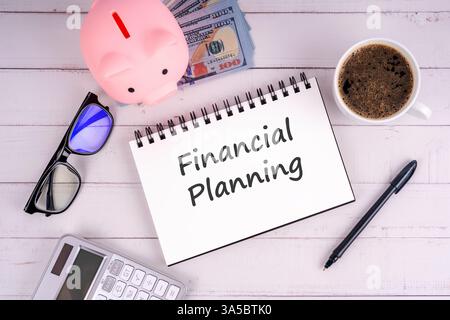 Financial plan text on notepad flat lay Stock Photo