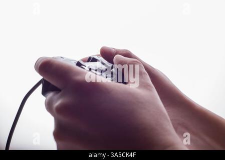 black gaming joystick in hands on white background Stock Photo