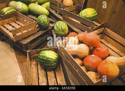 Watermelons and pumpkins, in a wooden box, on pallets, supermarket, lifestyle, no people, mobile photo Stock Photo