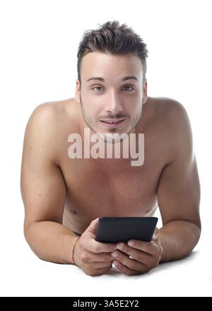 Attractive, fit young man holding ebook reader or tablet, smiling to camera Stock Photo