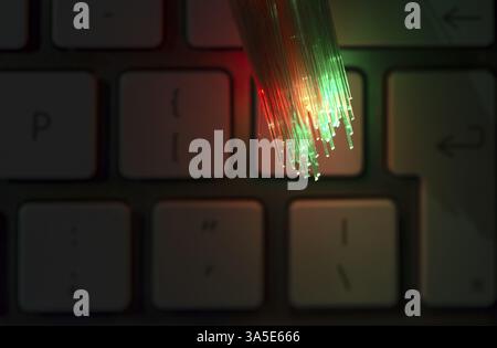 Colourful optic fibers illuminated on keyboard. High speed internet concept. Data transfer optic fiber cable. Bunch of many optical fibers, glowing di Stock Photo