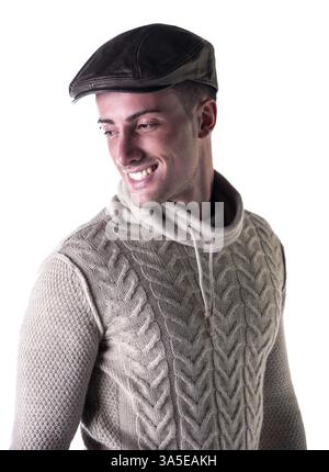 Handsome young man smiling, wearing knitted wool white sweater and leather hat Stock Photo