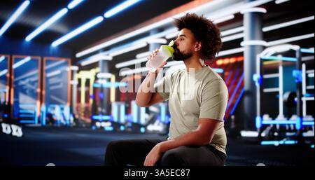 Muscular African American Gym Goer Taking a Hydration Break Stock Photo