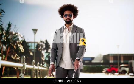 Blind Man Walking On Sidewalk Holding Stick Wearing Armband. Stock Photo