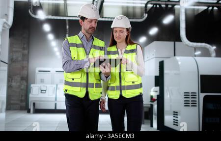 Manager Training New Factory Employee on Semiconductor Manufacturing Equipment Industry Stock Photo