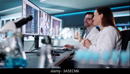 Medical Professionals Engaged in Virtual Discussion at High-Tech Laboratory Stock Photo
