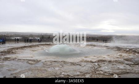 Geyser erupting in Iceland, producing big splash of hot water and steam ...